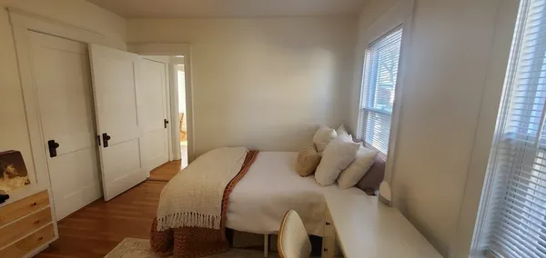 a bedroom with a bed and a window