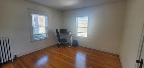 a workspace with wooden floor and a window
