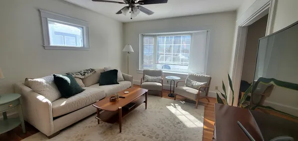 a living room with furniture and windows