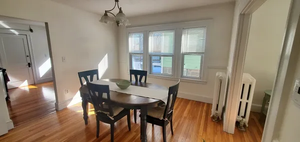 a view of a dining room with furniture window and wooden floor