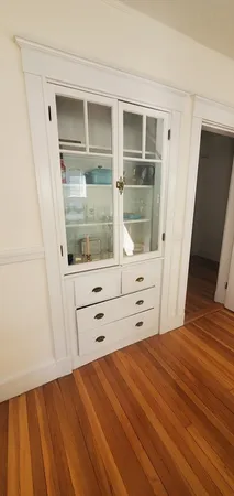 a view of room with window and wooden floor