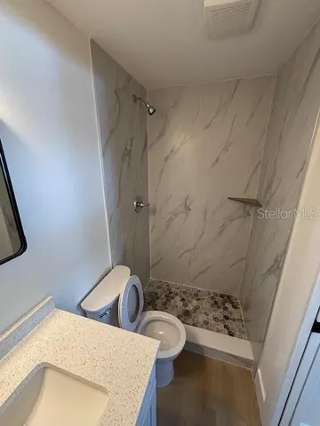a bathroom with a sink and shower