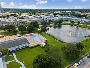 an aerial view of a house with a garden and lake view