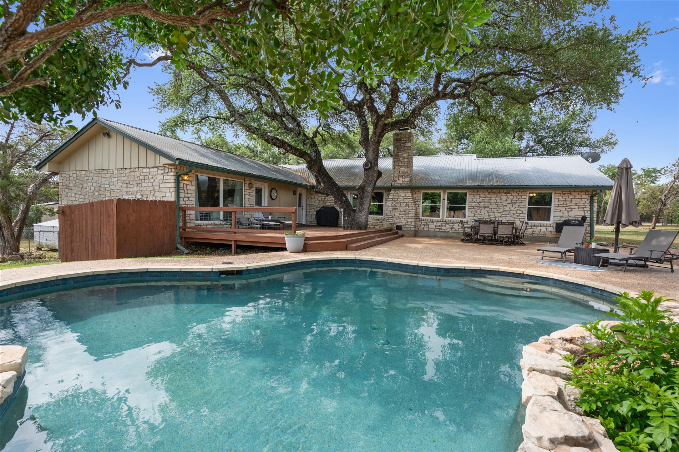 720 Circle G Ranch Road Austin, TX 78737 - Photo 3 of 37 a front view of a house with swimming pool having outdoor seating