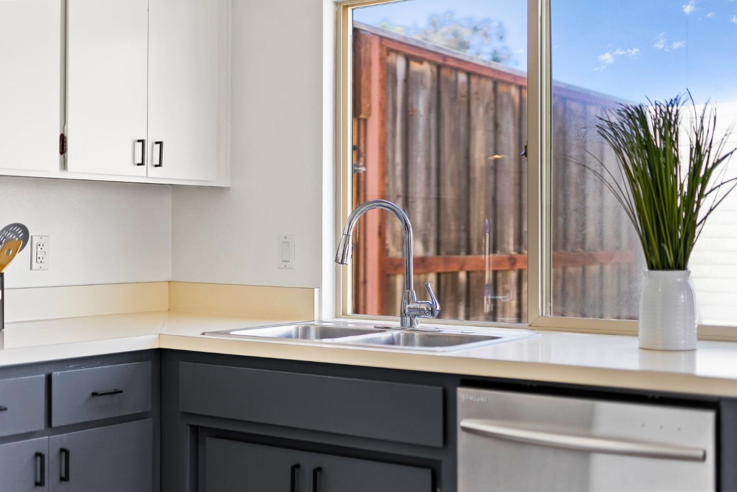 703 Sherman Circle Salinas, CA 93907 - Photo 16 of 25 a kitchen with a sink and a potted plant with wooden floor