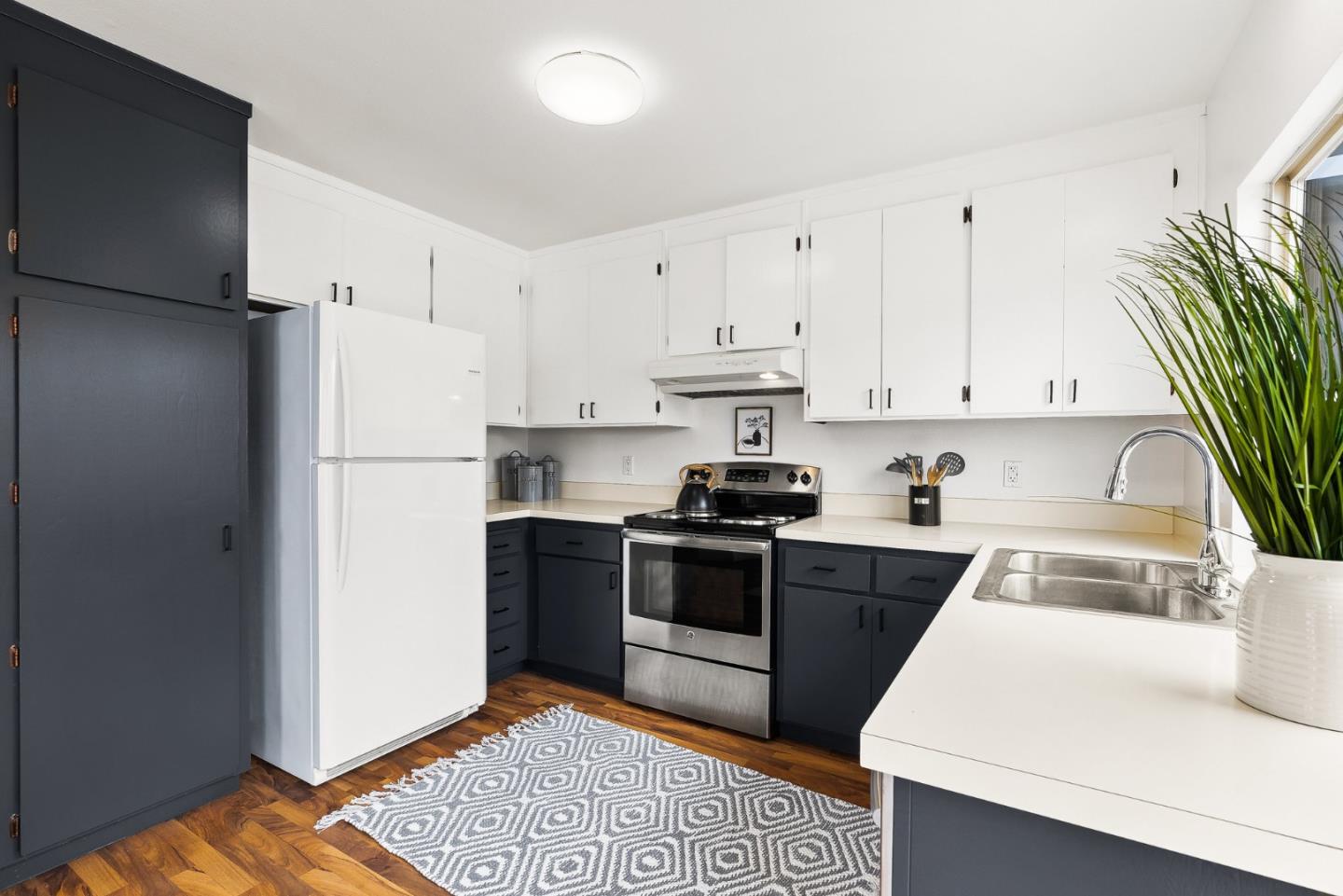 703 Sherman Circle Salinas, CA 93907 - Photo 5 of 25 a kitchen with cabinets and stainless steel appliances