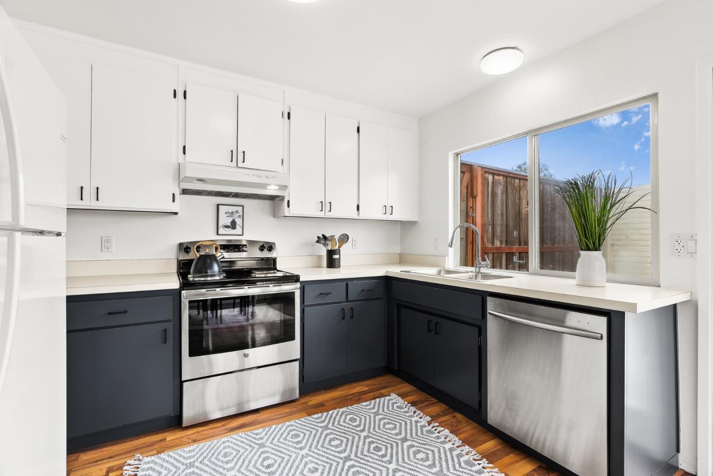 703 Sherman Circle Salinas, CA 93907 - Photo 6 of 25 a kitchen with stainless steel appliances granite countertop a stove a sink and a refrigerator