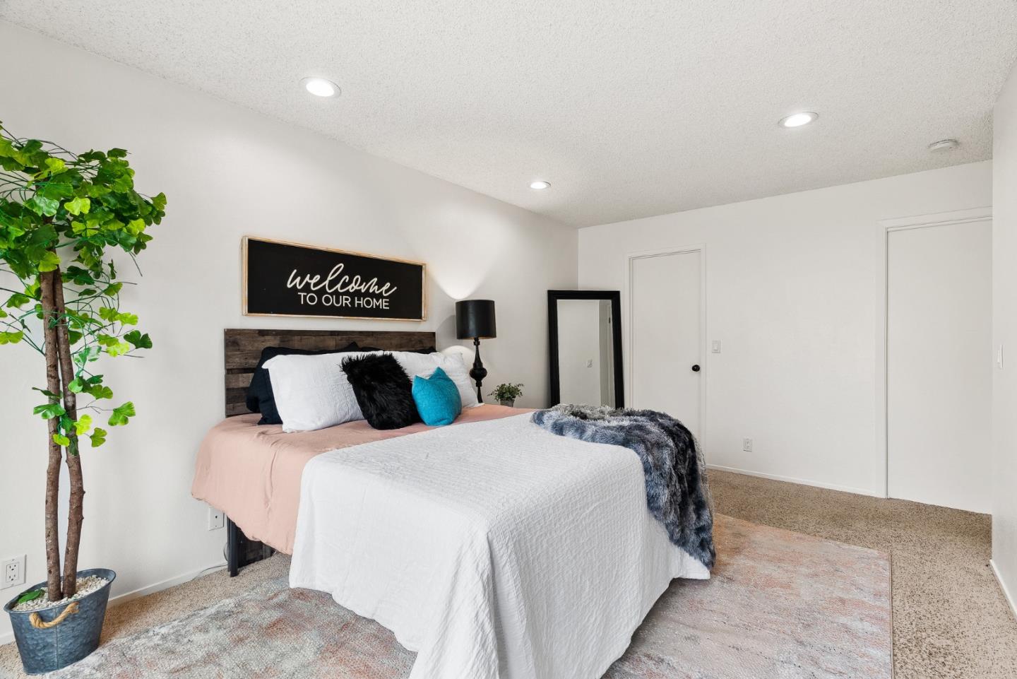 703 Sherman Circle Salinas, CA 93907 - Photo 8 of 25 a bedroom with bed and a potted plant