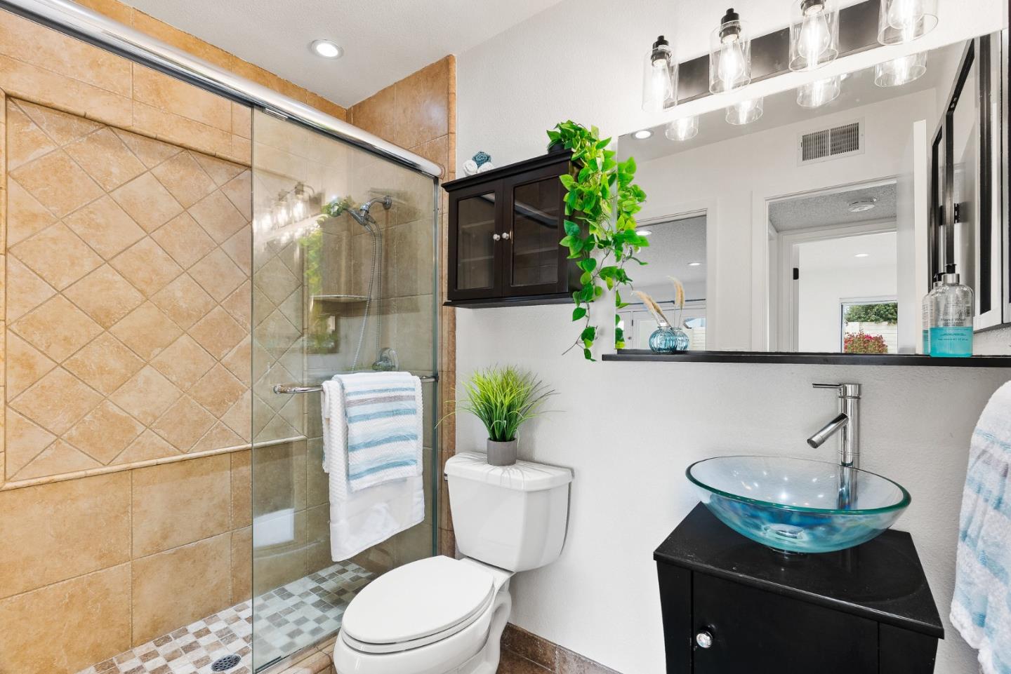 703 Sherman Circle Salinas, CA 93907 - Photo 10 of 25 a bathroom with a sink a toilet a mirror and shower