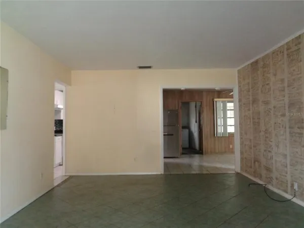 a view of a hallway with wooden shelves
