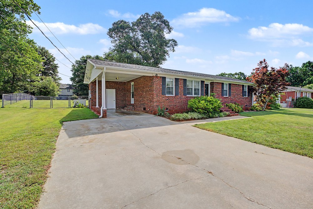 115 Brunson Drive Pickens, SC 29671 - Photo 3 of 29 A classic brick exterior with a welcoming carport offers timeless curb appeal.