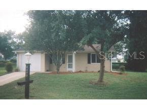 8490 Southwest 109th Lane Road Ocala, FL 34481 - Photo 1 of 1 a black and white house with a yard