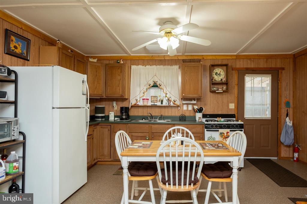 49 Mount Top Road Baker, WV 26801 - Photo 11 of 34 a kitchen with stainless steel appliances granite countertop a dining table and chairs