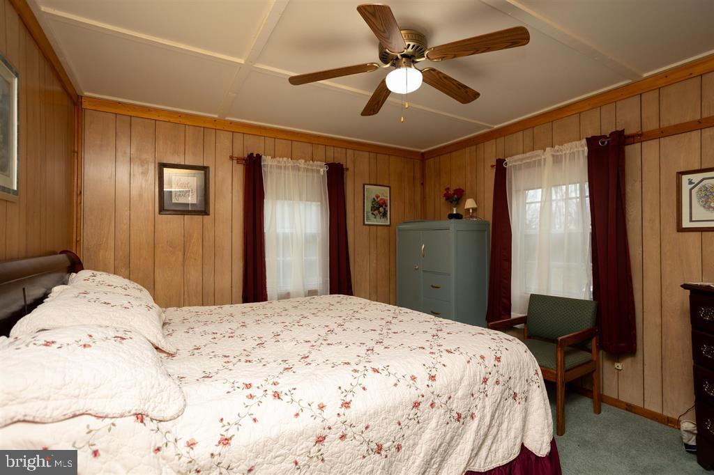 49 Mount Top Road Baker, WV 26801 - Photo 15 of 34 a bedroom with a large bed and a chandelier