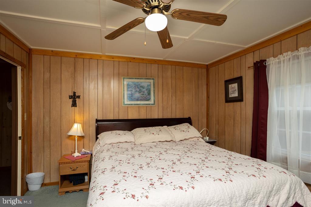 49 Mount Top Road Baker, WV 26801 - Photo 17 of 34 a bedroom with a bed and a chandelier