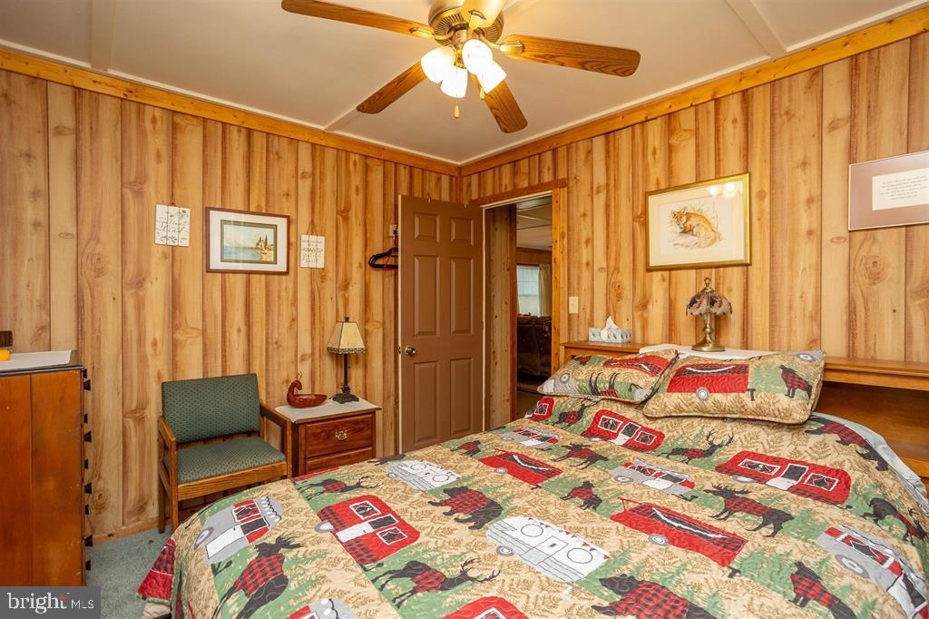 49 Mount Top Road Baker, WV 26801 - Photo 19 of 34 a bedroom with a bed and a chandelier