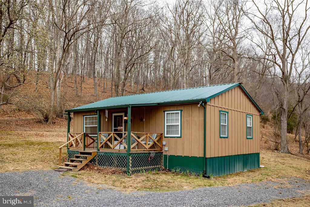 49 Mount Top Road Baker, WV 26801 - Photo 2 of 34 a front view of a house with garden