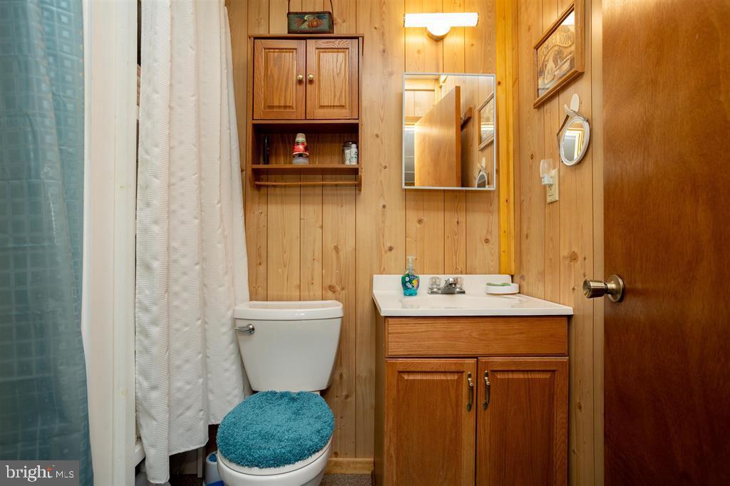 49 Mount Top Road Baker, WV 26801 - Photo 21 of 34 a bathroom with a toilet a sink and mirror