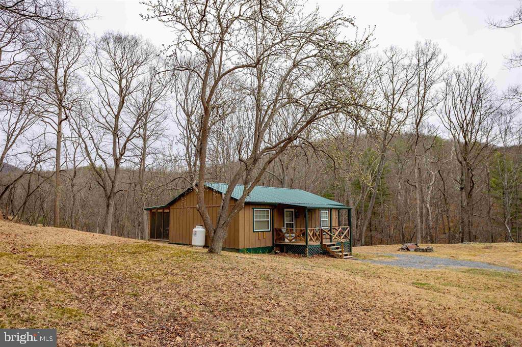 49 Mount Top Road Baker, WV 26801 - Photo 29 of 34 a front view of a house with a yard covered in snow