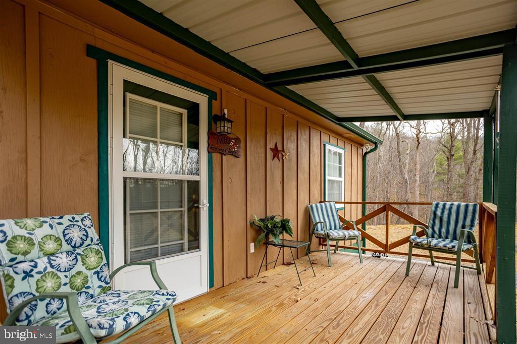 49 Mount Top Road Baker, WV 26801 - Photo 4 of 34 a patio with glass top table and chairs