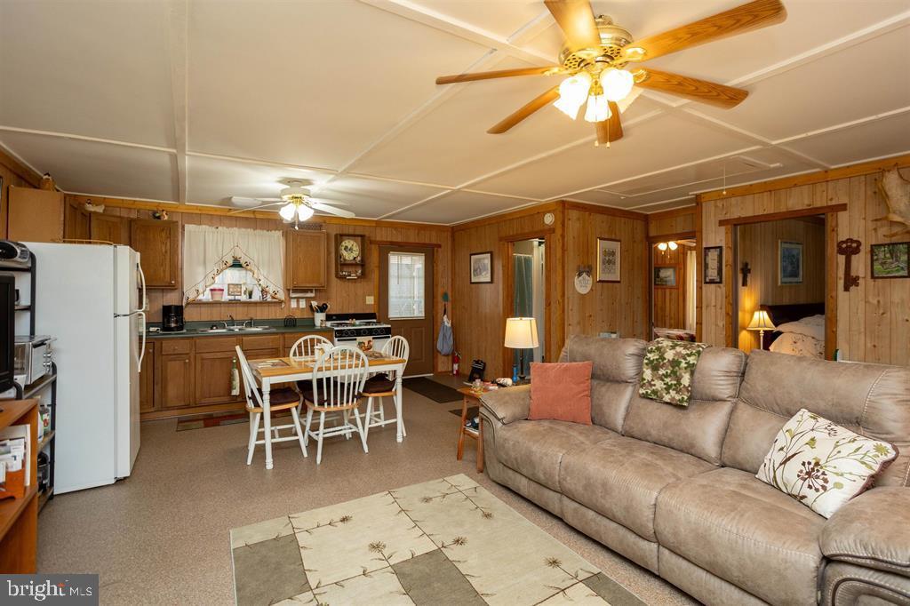 49 Mount Top Road Baker, WV 26801 - Photo 5 of 34 a living room with furniture a chandelier and a dining table with kitchen view
