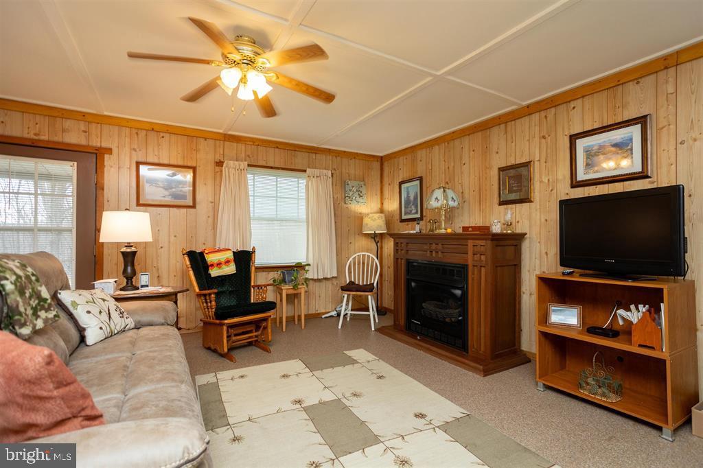 49 Mount Top Road Baker, WV 26801 - Photo 7 of 34 a living room with furniture a flat screen tv and a fireplace