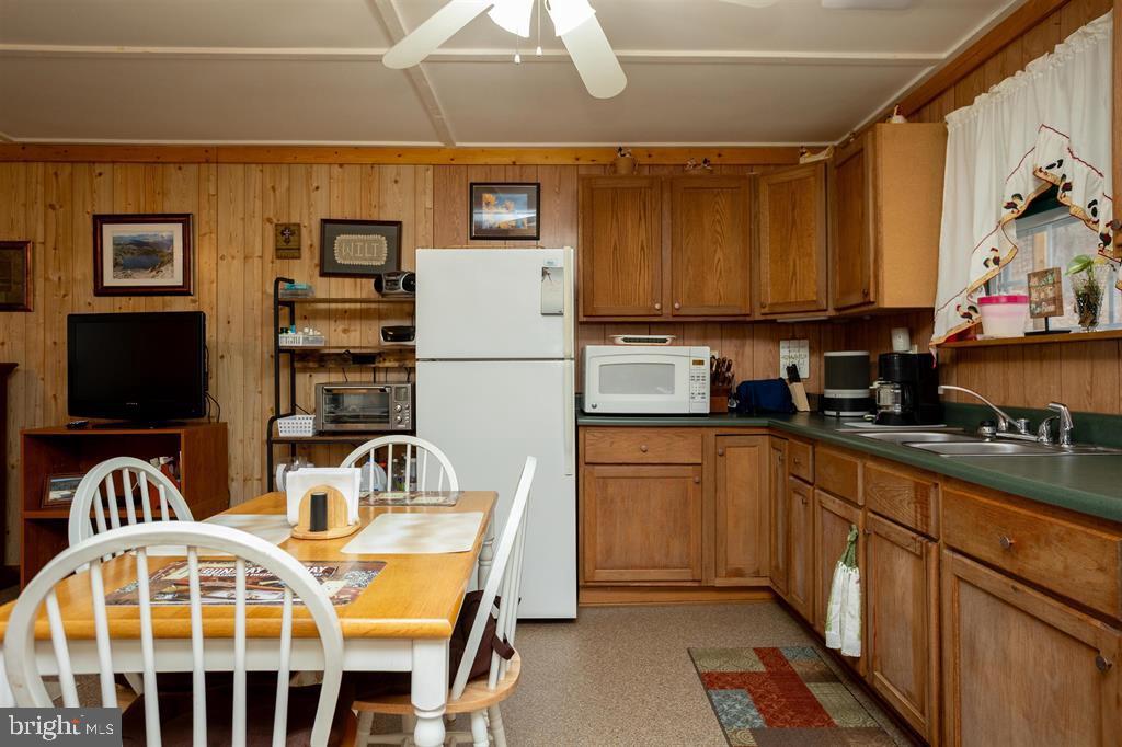 49 Mount Top Road Baker, WV 26801 - Photo 10 of 34 a kitchen with stainless steel appliances a stove a sink and a refrigerator