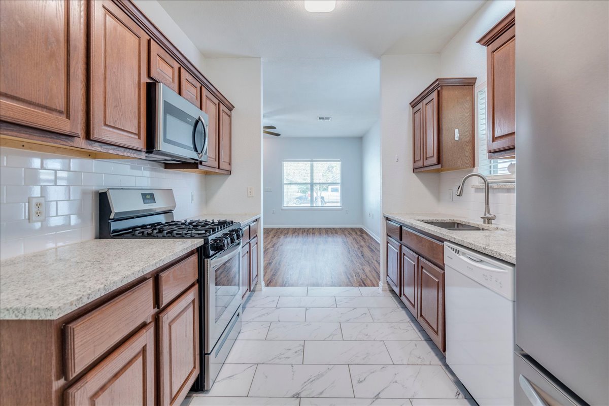6801 Porter Street Austin, TX 78741 - Photo 10 of 30 A well-appointed kitchen features rich cabinetry, sleek countertops, and modern appliances.