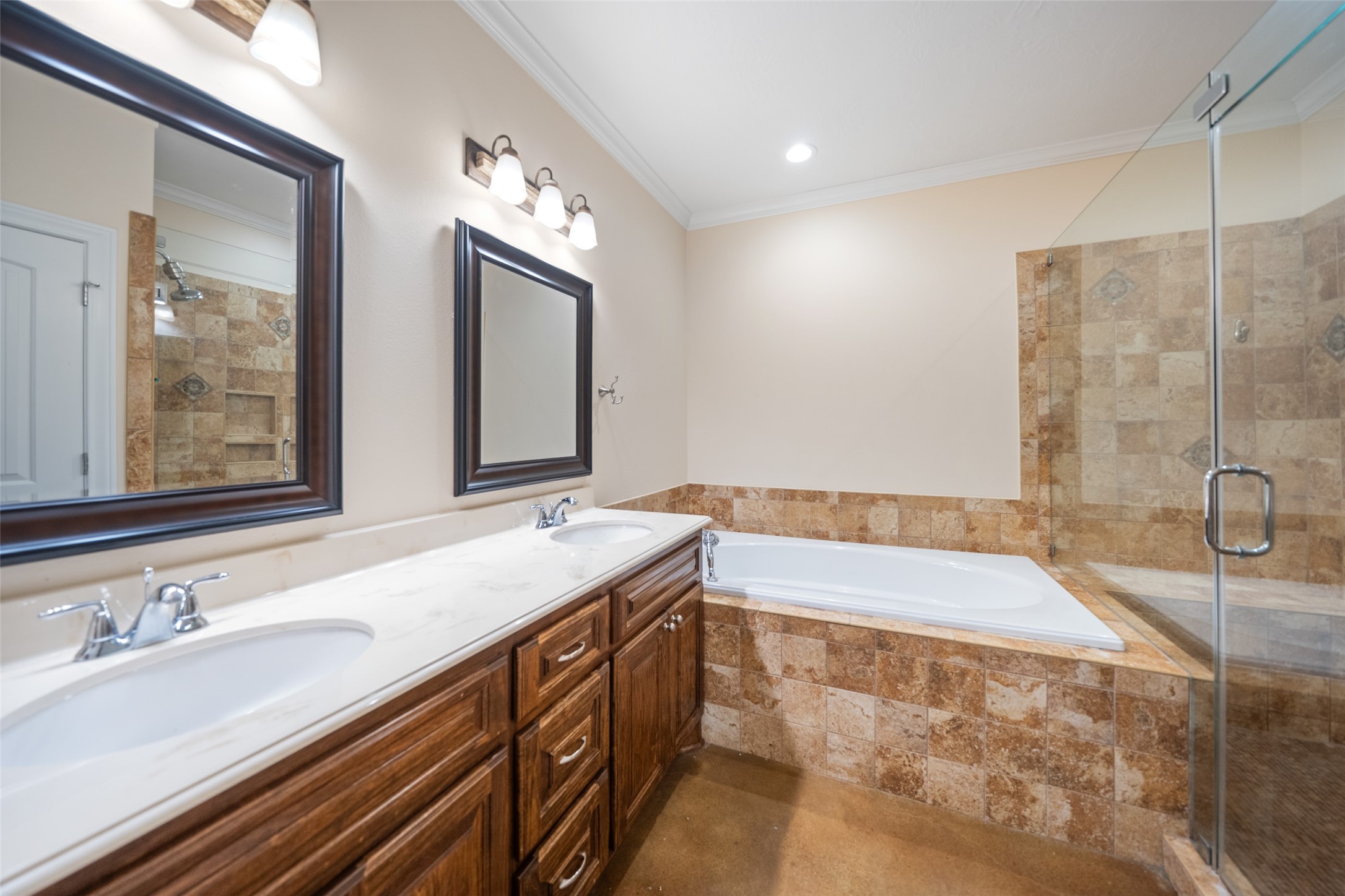 26752 Nelson Road Hempstead, TX 77445 - Photo 22 of 45 Primary bath includes a dual-sink vanity, framed mirrors, soaking tub, and a separate tiled walk-in shower with glass enclosure.
