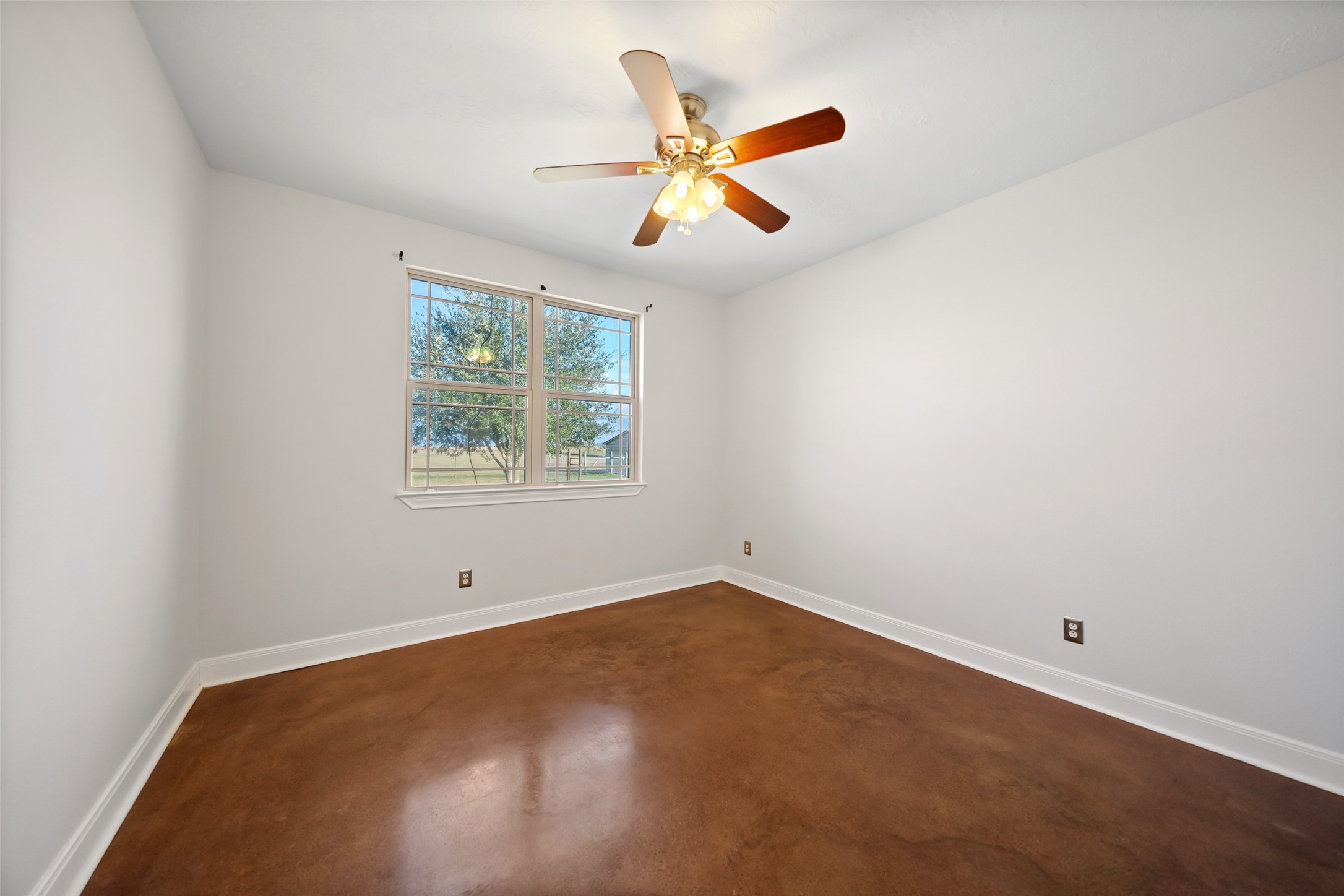 26752 Nelson Road Hempstead, TX 77445 - Photo 30 of 45 Other secondary bedroom highlights the clean layout, natural light, and durable concrete floors, ideal for everyday living.