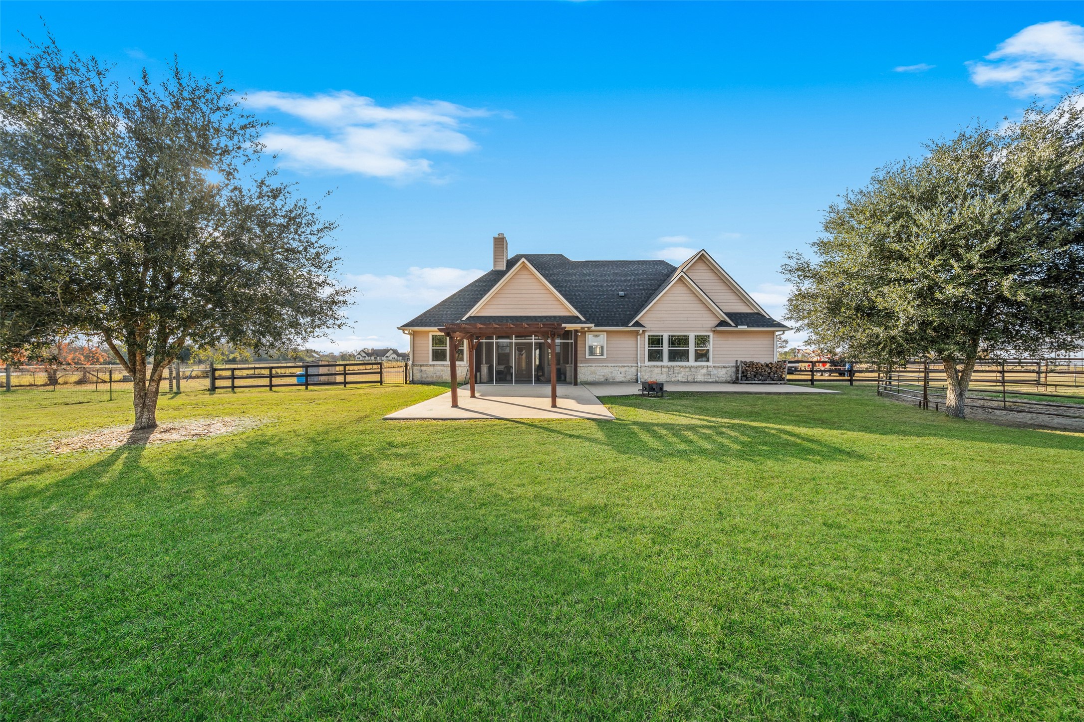 26752 Nelson Road Hempstead, TX 77445 - Photo 3 of 45 The screened-in patio extends outdoor living space and overlooks a fenced backyard with open lawn beyond.