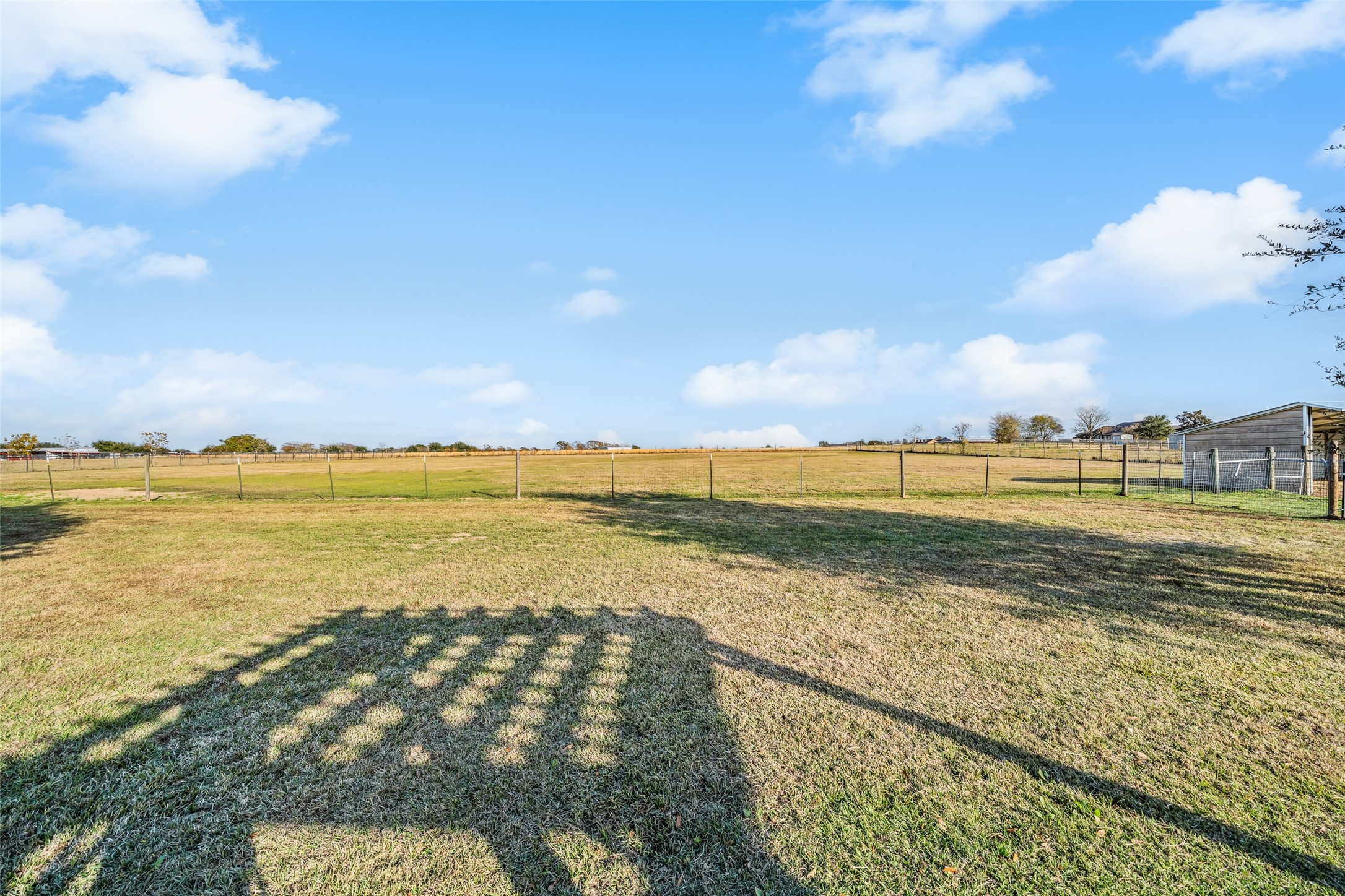 26752 Nelson Road Hempstead, TX 77445 - Photo 33 of 45 Open, fenced pasture offers wide-open views and usable space suitable for livestock, recreation, or future improvements.