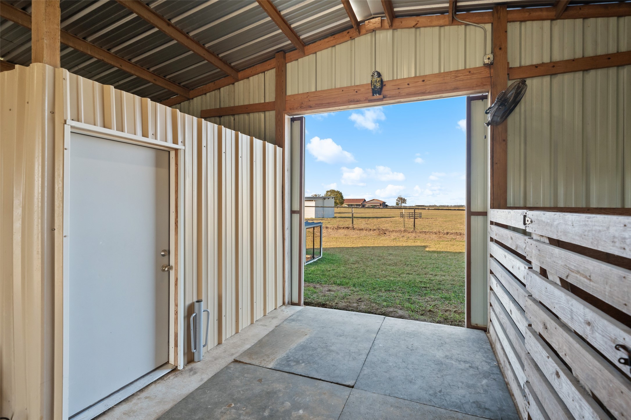 26752 Nelson Road Hempstead, TX 77445 - Photo 38 of 45 Interior of the barn includes enclosed stall space with durable materials, concrete flooring, and large openings for airflow and easy access.