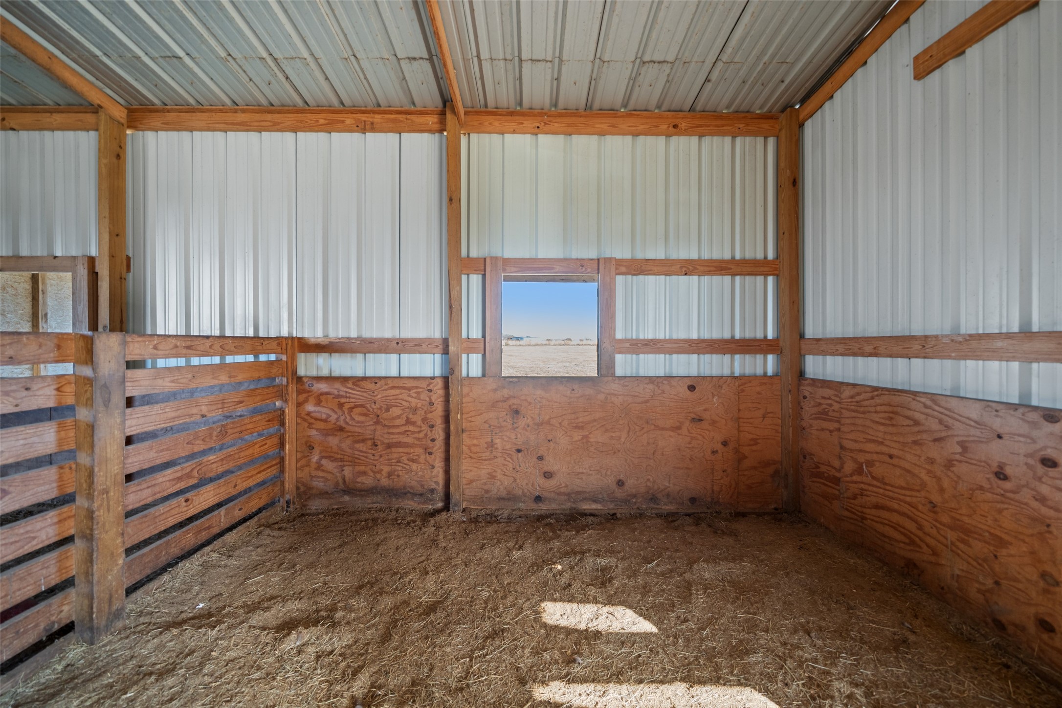 26752 Nelson Road Hempstead, TX 77445 - Photo 39 of 45 Barn includes enclosed stalls with wood kickboards and durable construction, suitable for horses or livestock.