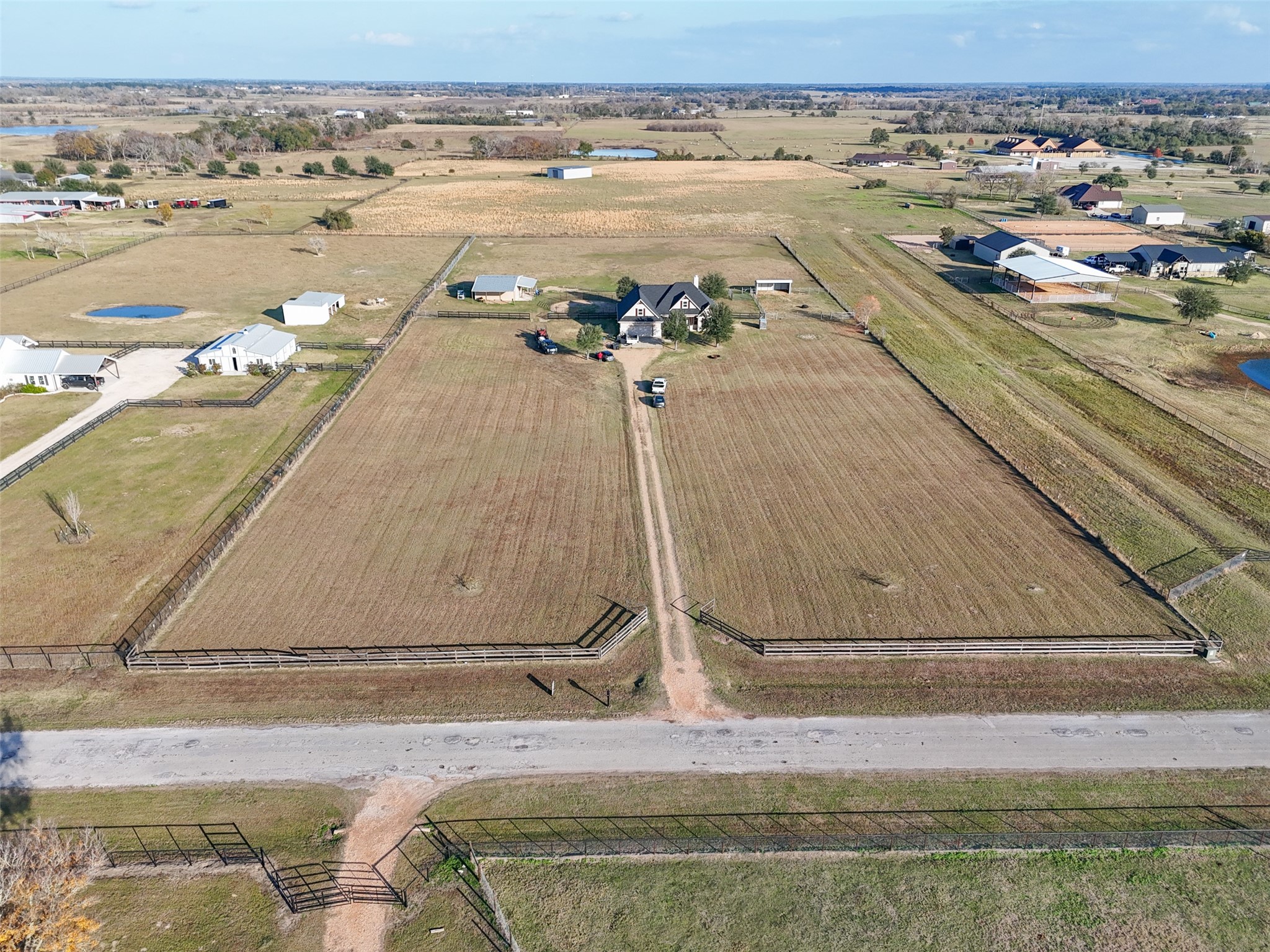 26752 Nelson Road Hempstead, TX 77445 - Photo 44 of 45 Wide aerial view highlights perimeter fencing, private drive, and clear road frontage leading directly to the homesite.
