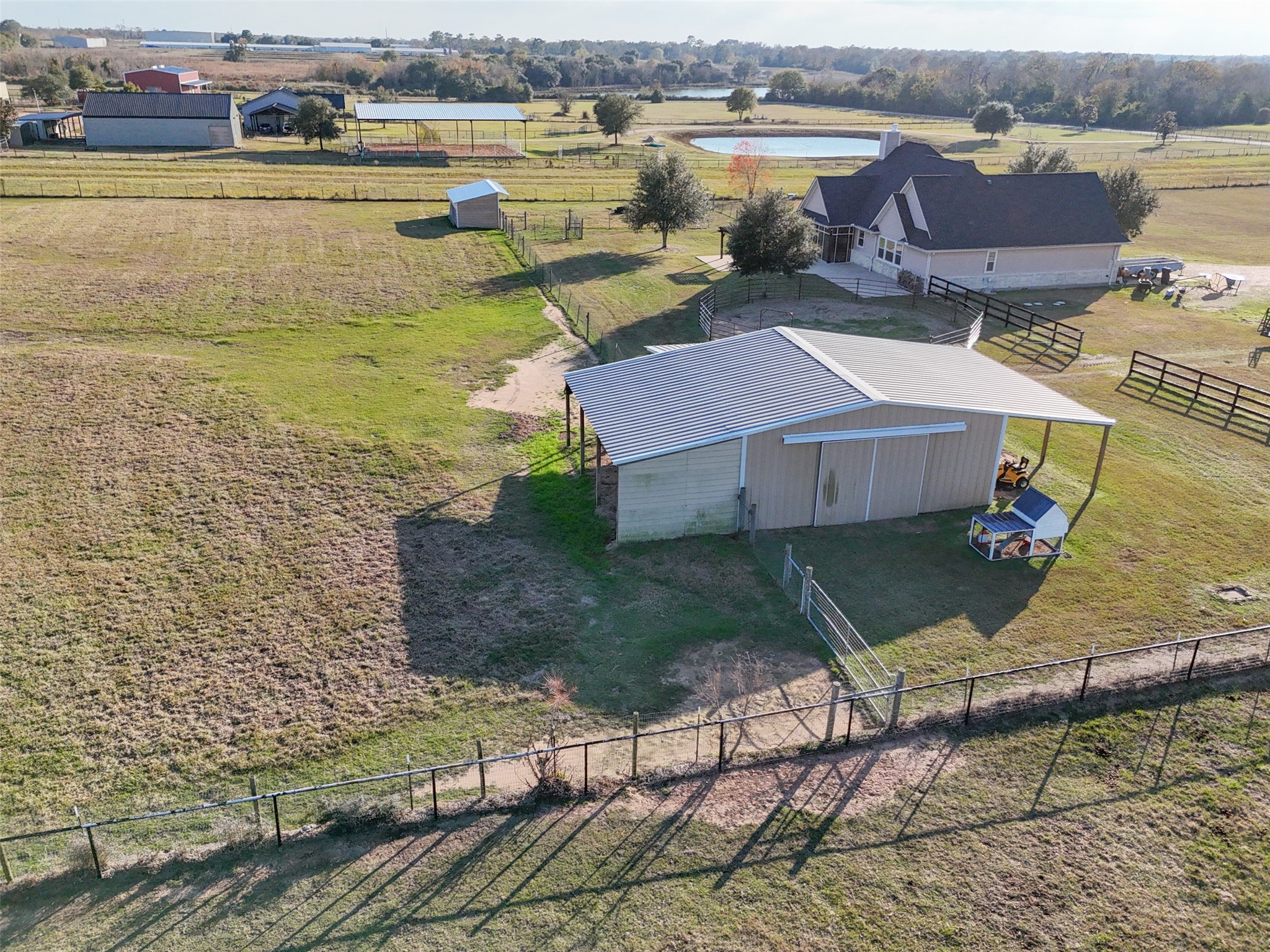 26752 Nelson Road Hempstead, TX 77445 - Photo 45 of 45 Aerial angle shows the barn, adjacent paddocks, and fencing layout designed for rotational grazing or livestock management.