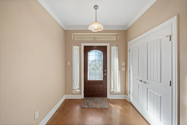 an empty room with fireplace and a ceiling fan