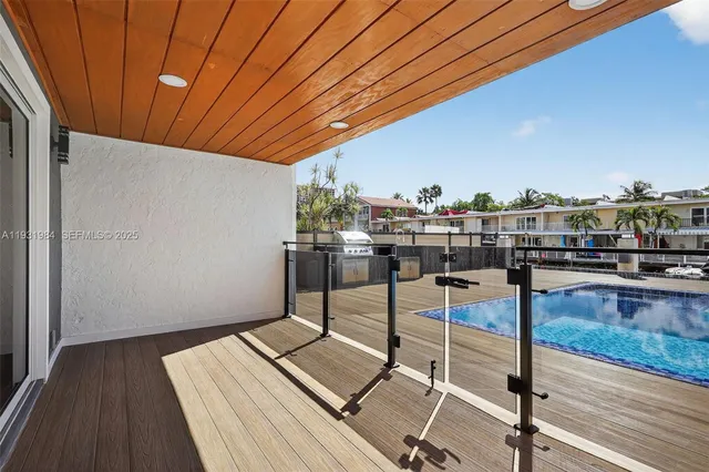 a kitchen with stainless steel appliances kitchen island granite countertop a refrigerator and cabinets