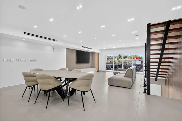 a large white kitchen with sink and cabinets
