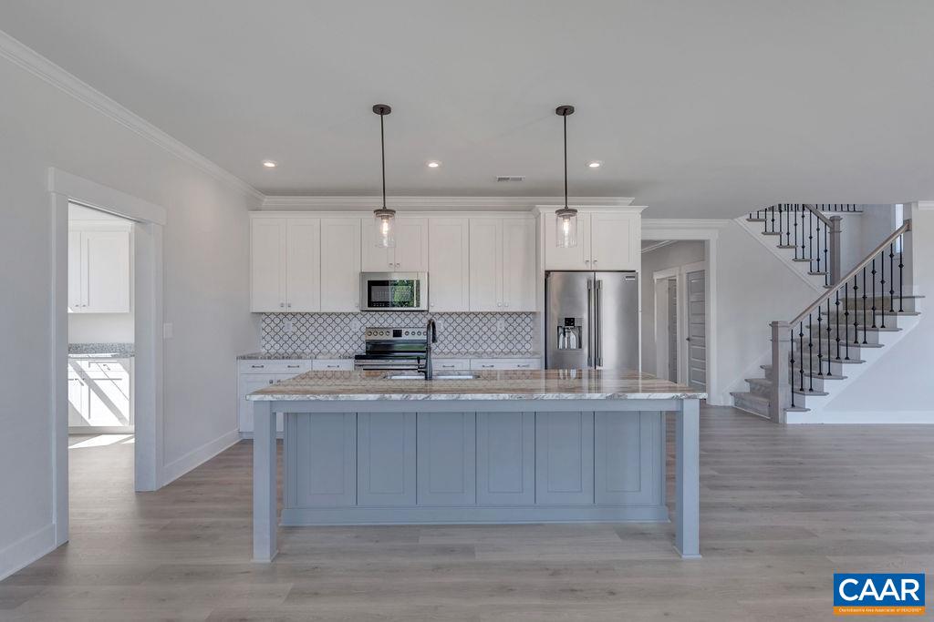 754 Arboleda Drive Crozet, VA 22932 - Photo 12 of 39 a kitchen with stainless steel appliances granite countertop a sink a refrigerator and a stove