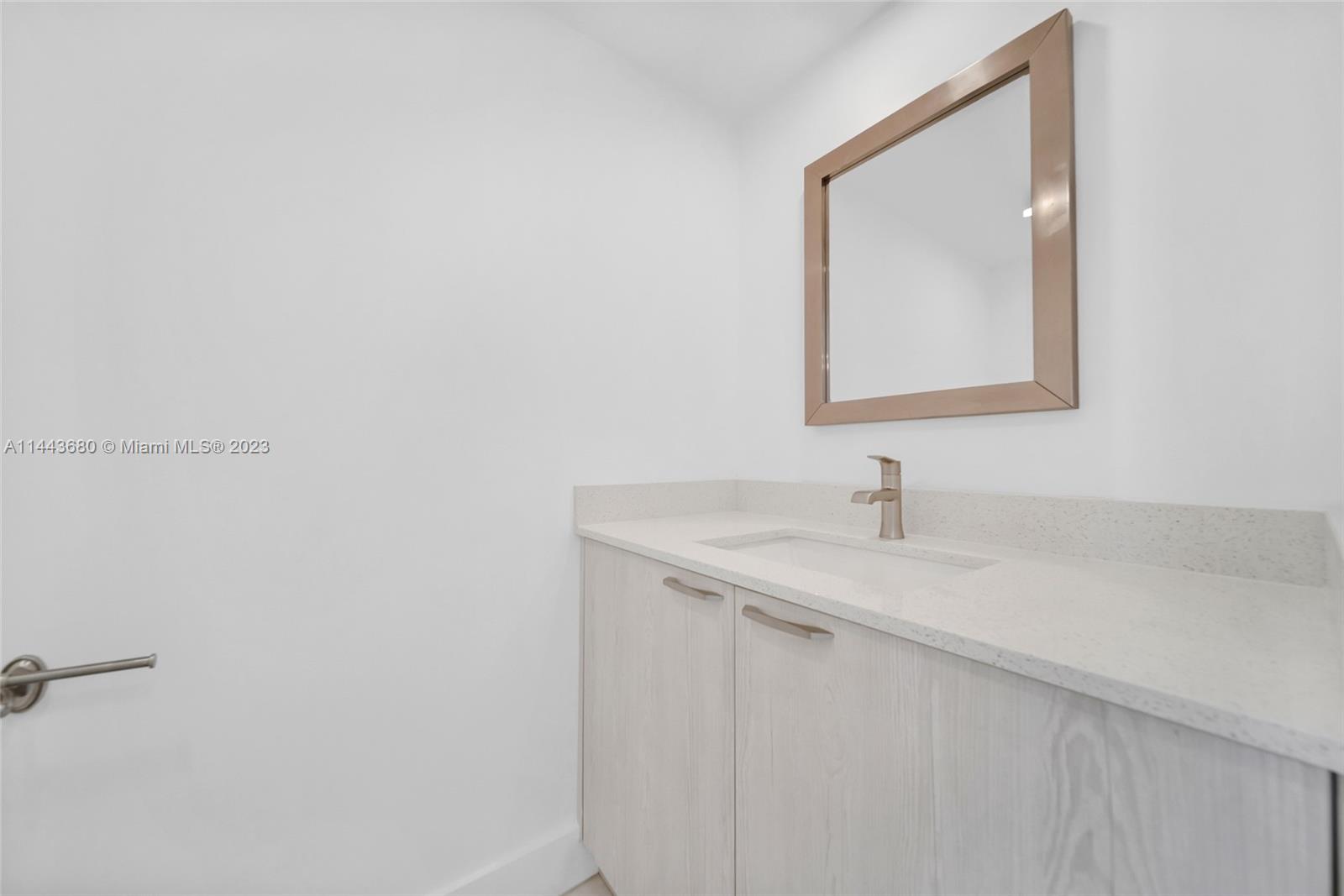 Brickell Key Miami, FL 33131 - Photo 11 of 40 a bathroom with a sink and a mirror