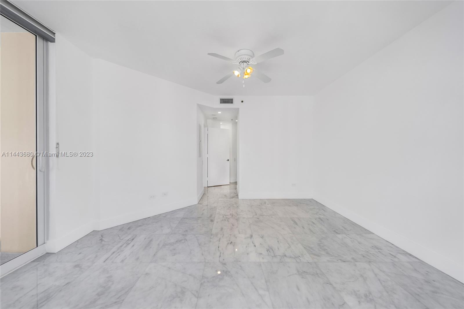 Brickell Key Miami, FL 33131 - Photo 16 of 40 an empty room with an entryway and kitchen view