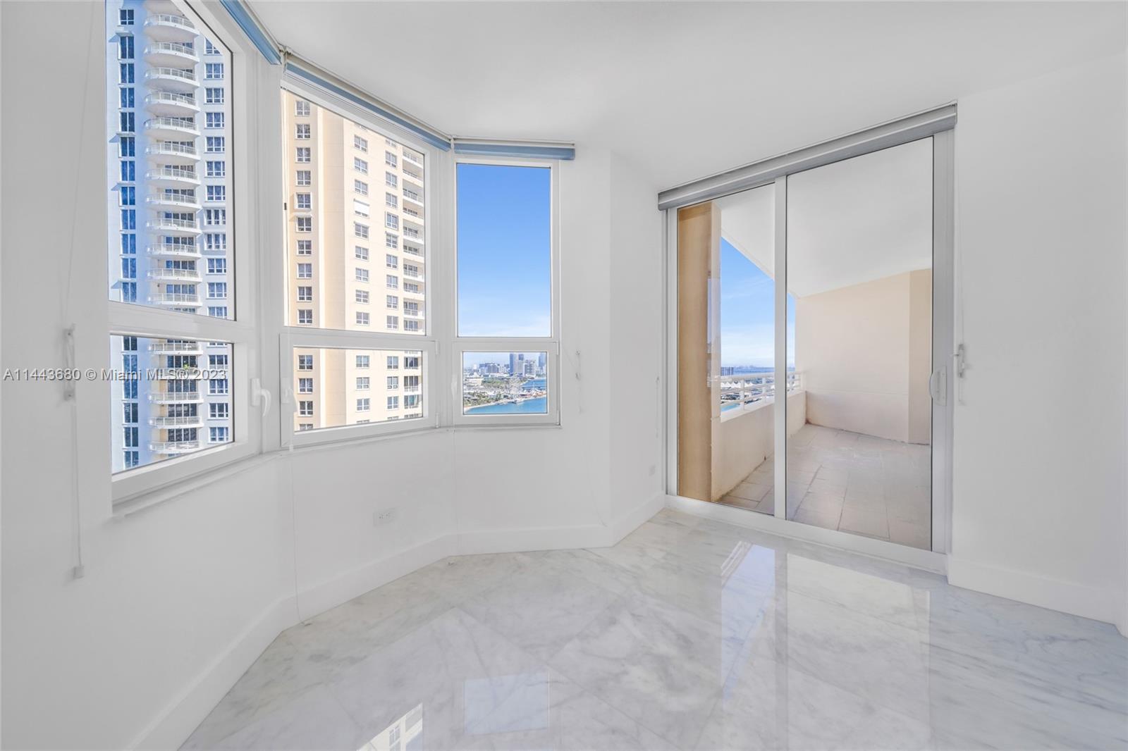 Brickell Key Miami, FL 33131 - Photo 17 of 40 an empty room with windows and closet