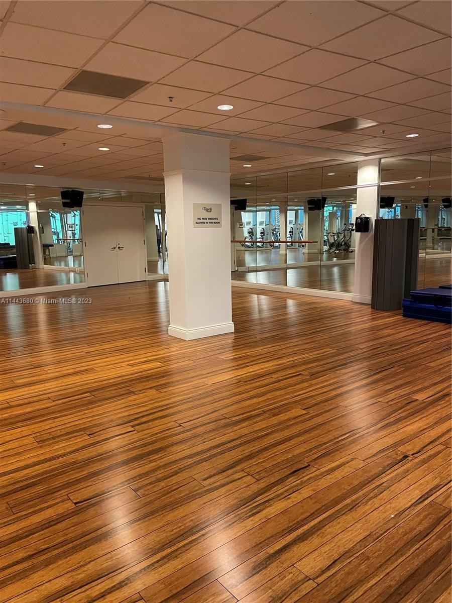 Brickell Key Miami, FL 33131 - Photo 28 of 40 an empty room with wooden floor and a floor to ceiling window