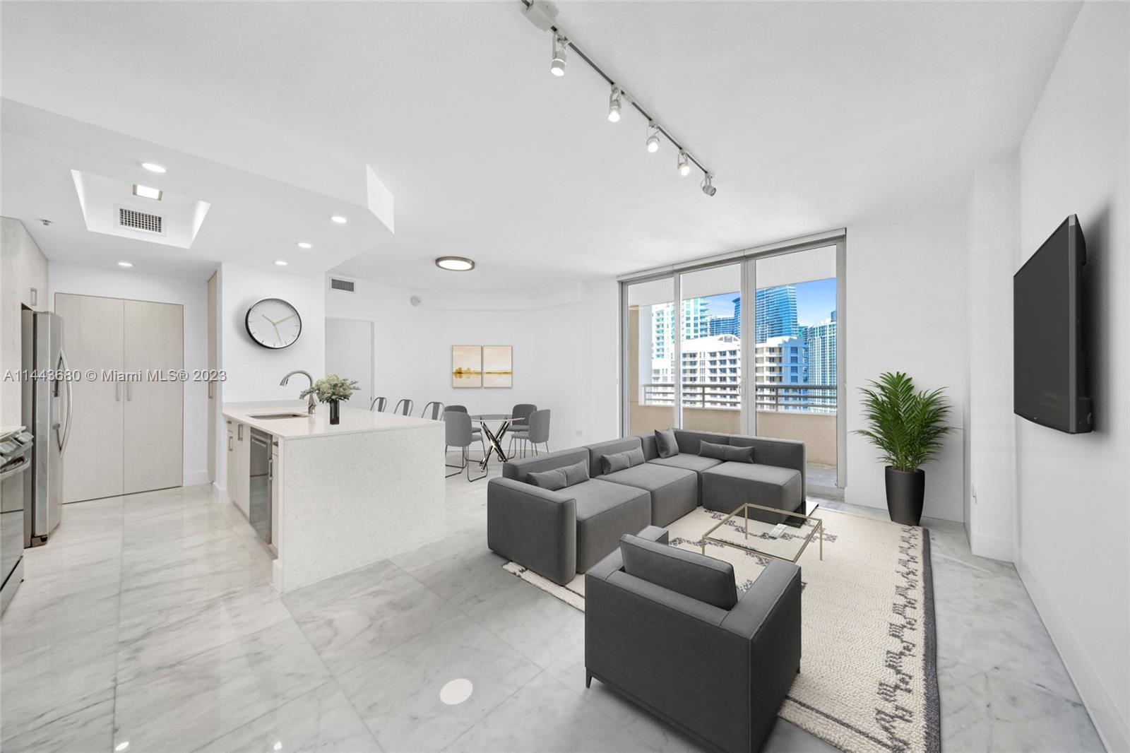 Brickell Key Miami, FL 33131 - Photo 5 of 40 a living room with furniture and a flat screen tv