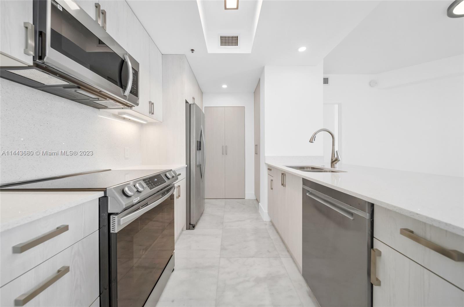 Brickell Key Miami, FL 33131 - Photo 6 of 40 a kitchen with stainless steel appliances granite countertop a stove and a sink