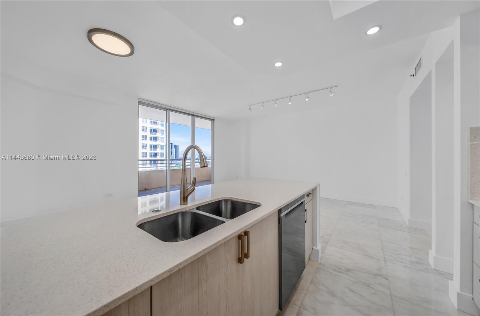 Brickell Key Miami, FL 33131 - Photo 7 of 40 a kitchen with a sink and cabinets