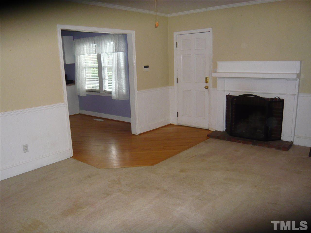 4613 Auburn Knightdale Road Raleigh, NC 27610 - Photo 12 of 25 a view of an empty room with window and fire place