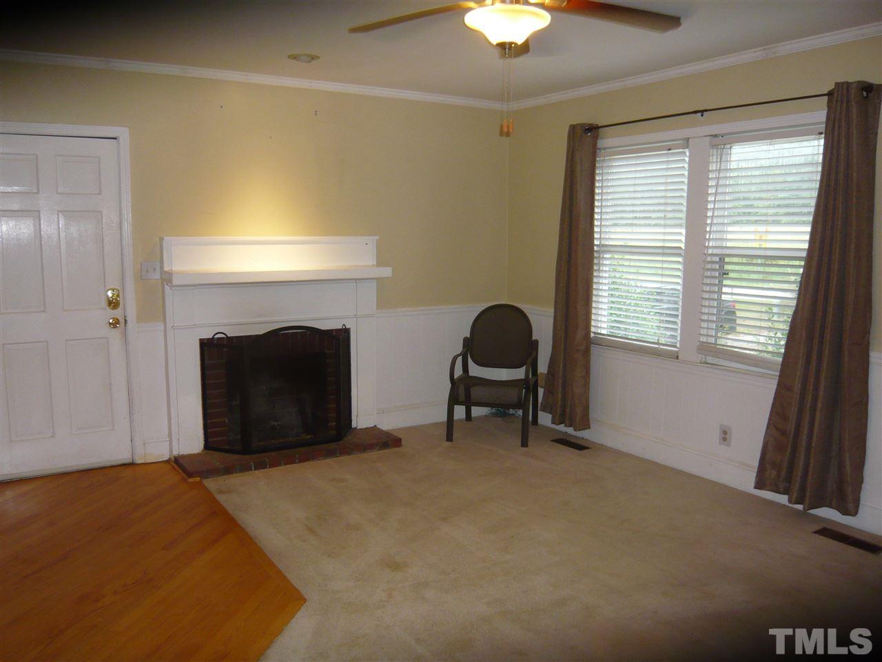 4613 Auburn Knightdale Road Raleigh, NC 27610 - Photo 13 of 25 a living room with furniture and a fireplace