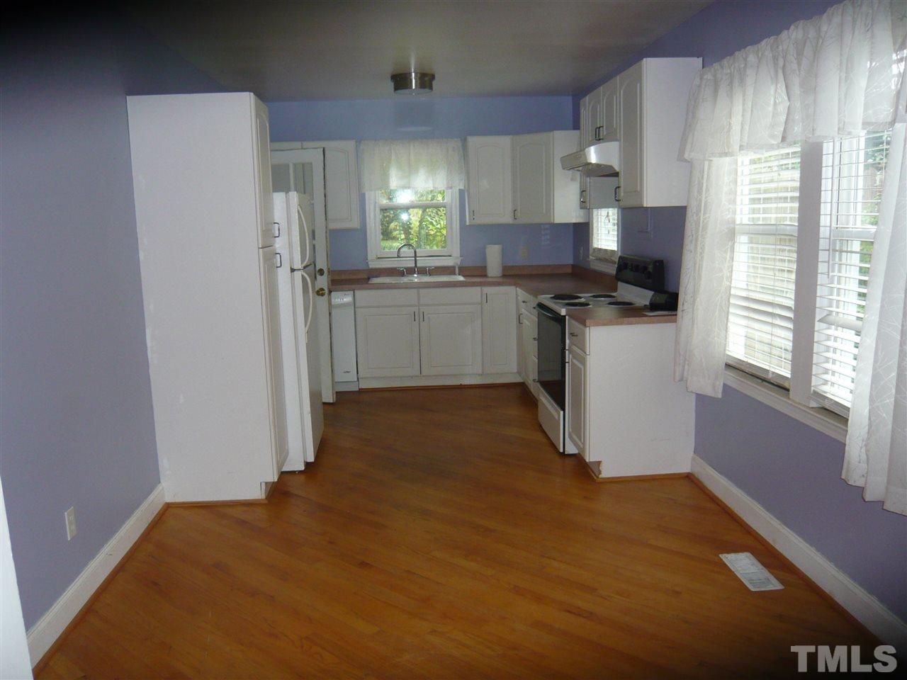 4613 Auburn Knightdale Road Raleigh, NC 27610 - Photo 14 of 25 a kitchen with stainless steel appliances a refrigerator sink and cabinets